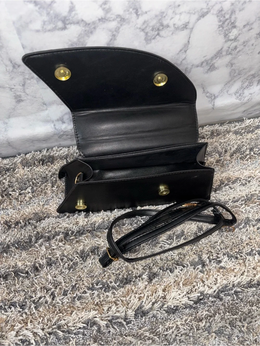Elegant Black Textured Clutch with Gold Accent Handle
